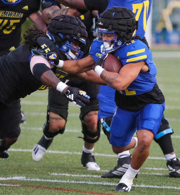 Delaware defensive lineman Keyshawn Hunter tackles running back Ronnie Heath during the Blue and White Spring Game at Delaware Stadium, Friday, April 19, 2024.