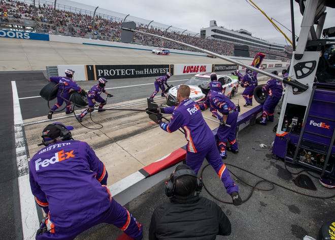 Denny Hamlin makes a pit stop during the NASCAR Cup Series playoff auto race Sunday, Oct. 6, 2019, at Dover International Speedway in Dover.