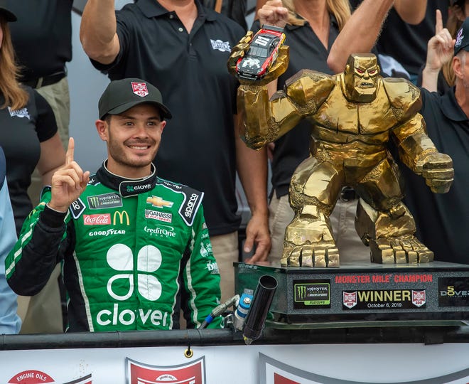 Kyle Larson stands next to the trophy after winning the NASCAR Cup Series auto race Sunday, Oct. 6, 2019, at Dover International Speedway in Dover.