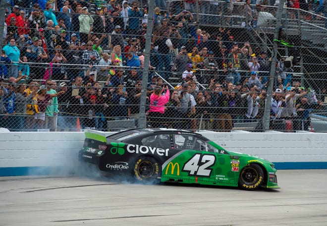 Kyle Larson does a burnout after winning the NASCAR Cup Series playoff auto race Sunday, Oct. 6, 2019, at Dover International Speedway in Dover.