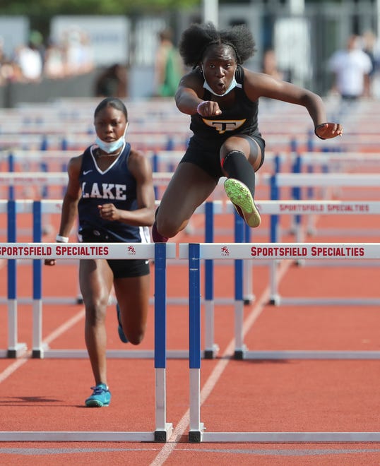 Tatnall's Alexis Tarlue (right) clears the last hurdle ahead of second place finisher Paris Drummer of Lake Forest in Tarlue's win in the Division II 100 meter hurdles on the second and final day of the DIAA state high school track and field championships Saturday, May 22, 2021 at Dover High School.