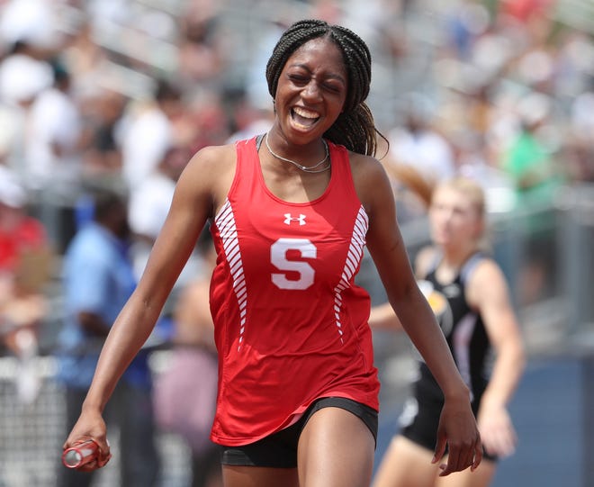 Smyrna's Elise Carter reacts after anchoring her team in its win of the Division I 4x200 meter relay on the second and final day of the DIAA state high school track and field championships Saturday, May 22, 2021 at Dover High School.