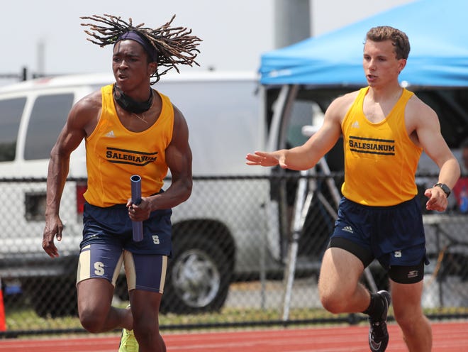 Salesianum's Jasyn Truitt (left) takes off after the baton exchange with teammate Matt Greenley in the Sals' Division I 4x200 meter relay win in the second and final day of the DIAA state high school track and field championships Saturday, May 22, 2021 at Dover High School.