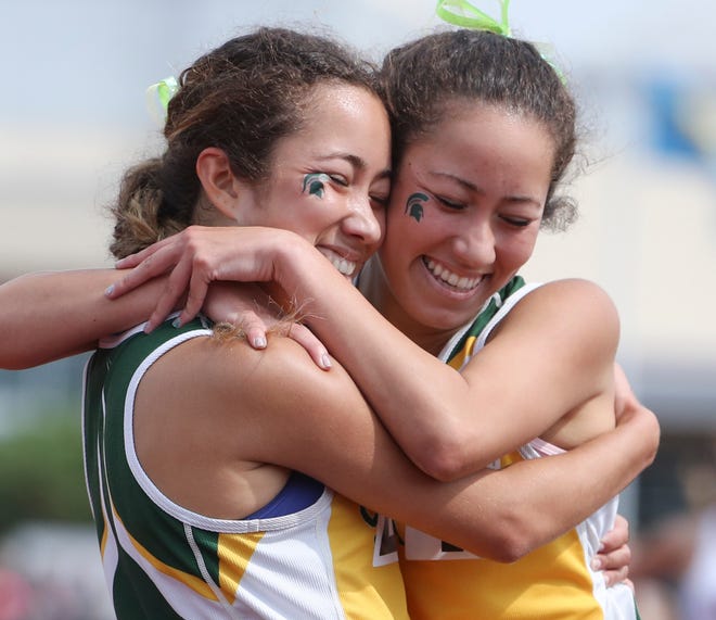 St. Mark's Stephanie Herrera (left) and Tiffany Herrera embrace after Tiffany won the 1600 meter run and Stephanie finished second by a fraction of a second on the second and final day of the DIAA state high school track and field championships Saturday, May 22, 2021 at Dover High School.