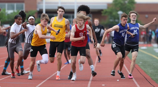 With multiple exchanges taking place simultaneously halfway thru the 4x400 relay, Salesianum's third leg (third from left) Andrew Mancini takes the baton from Luke Riley as Salesianum wins the event on the second and final day of the DIAA state high school track and field championships Saturday, May 22, 2021 at Dover High School.