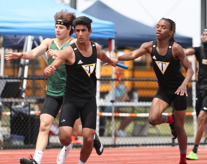 Tatnall's Manvir Syan (center) receives the baton from Micah Earnest as the Hornets win the Division II 4x400 relay race on the second and final day of the DIAA state high school track and field championships Saturday, May 22, 2021 at Dover High School.
