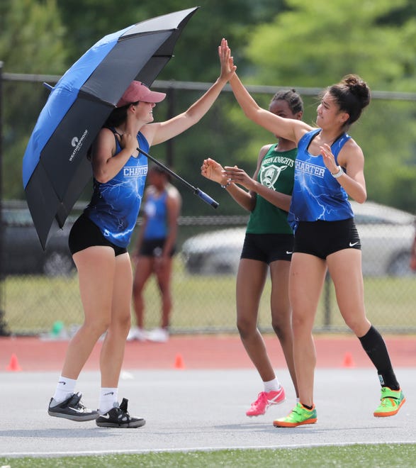 Wilmington Charter high jumper Claire Stella (left) congratulates teammate Samantha Uy after Uy cleared 5'2" to take second place in Division I on the second and final day of the DIAA state high school track and field championships Saturday, May 22, 2021 at Dover High School.