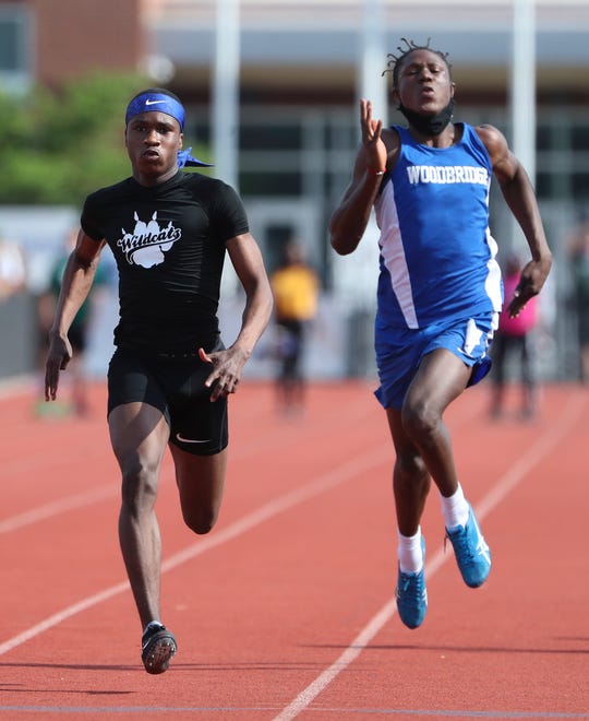 Howard's Zyaire Nuriddin (left) edges Woodbridge's Deronn Kane for first place in the Division II 100 meter dash on the second and final day of the DIAA state high school track and field championships Saturday, May 22, 2021 at Dover High School.