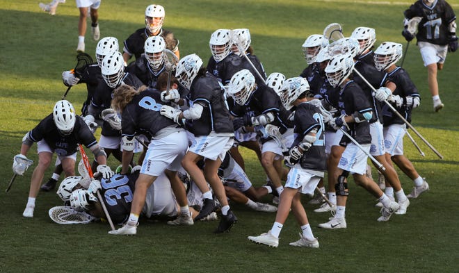 Cape Henlopen celebrates after beating the Warriors 16-15 to win at Sanford School in a semifinal of the DIAA state tournament Tuesday, May 25, 2021.