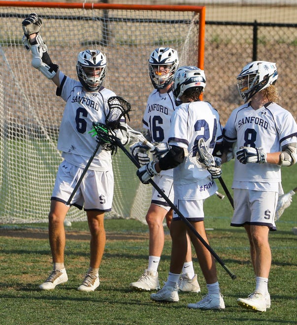 Sanford's (from left) Collin Campbell, James Gaylor, Dominic Pompeii and Reid Farmer celebrate a second half goal by Campbell in the Vikings' 16-15 win at Sanford School in a semifinal of the DIAA state tournament Tuesday, May 25, 2021.
