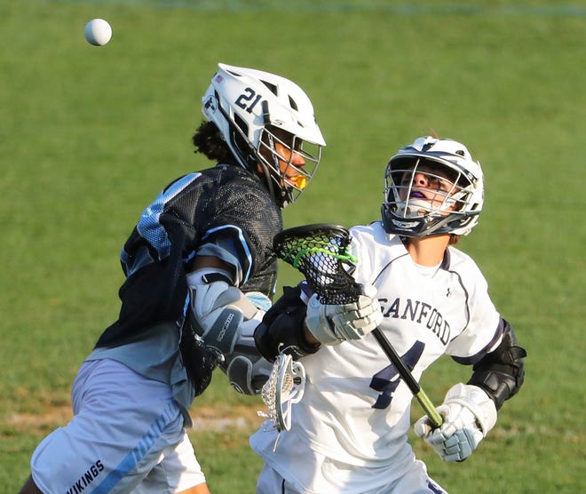 Cape Henlopen's Jaden Davis (left) and Sanford's Luca Pompeii fight for a loose ball in the second half of the Vikings' 16-15 win at Sanford School in a semifinal of the DIAA state tournament Tuesday, May 25, 2021.
