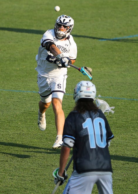 Sanford's Xander Bauguess shoots past Cape Henlopen's Drew Dennis in the second half of the Vikings' 16-15 win at Sanford School in a semifinal of the DIAA state tournament Tuesday, May 25, 2021.