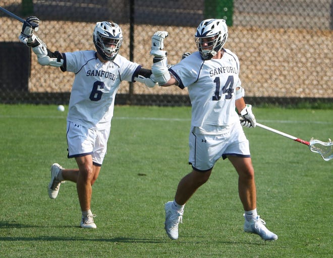Sanford's Timothy Lucky (right) celebrates a first half goal with Collin Campbell  the Vikings' 16-15 win at Sanford School in a semifinal of the DIAA state tournament Tuesday, May 25, 2021.