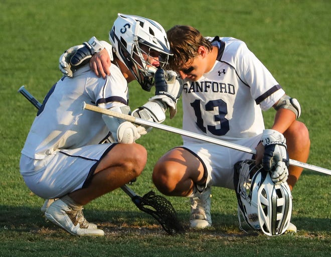 Sanford's Collin Campbell (left) and Spencer Zbranak come together after the Cape Henlopen's 16-15 win at Sanford School in a semifinal of the DIAA state tournament Tuesday, May 25, 2021.