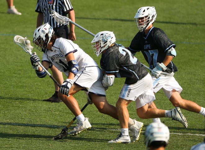 Sanford's Ian Binnersley (left) tries to move the ball away from Cape Henlopen's Charles Fritchman (center) and Landon Best in the first half of the Vikings' 16-15 win at Sanford School in a semifinal of the DIAA state tournament Tuesday, May 25, 2021.