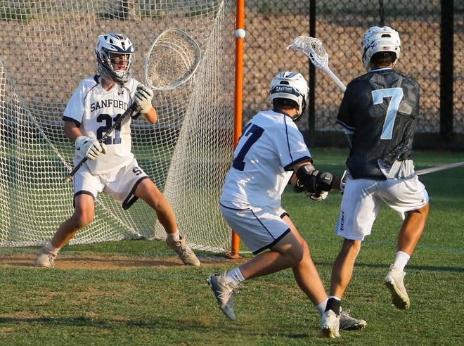 Sanford goalie Cameron Taylor (21) eyes a shot by Cape Henlopen's Gabriel Best in the second half of the Vikings' 16-15 win at Sanford School in a semifinal of the DIAA state tournament Tuesday, May 25, 2021.