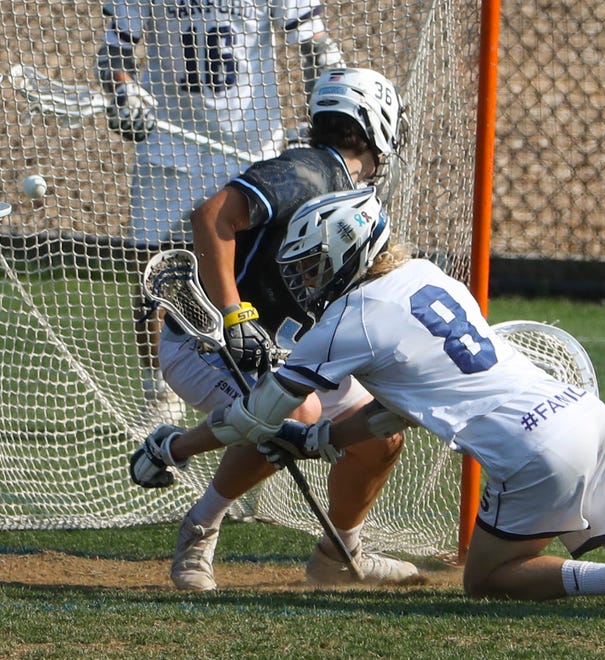 Sanford's Reid Farmer gets the ball in the net before he falls toward the crease and Cape Henlopen goalie Michael Sposato in the first half of the Vikings' 16-15 win at Sanford School in a semifinal of the DIAA state tournament Tuesday, May 25, 2021.