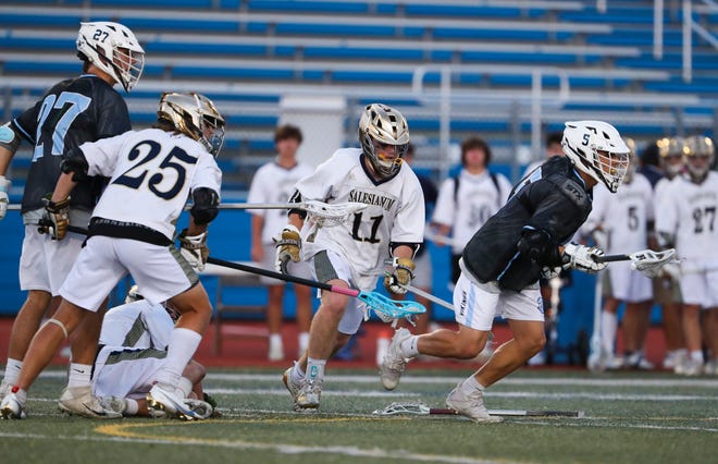 Cape Henlopen's Andrew Wolak (right) takes off for the ball on a face-off with teammate Landon Best (left) and Salesianum's Dominic Rottura (25) and Colby Bushweller in the first half of the DIAA state tournament championship game Thursday, May 27, 2021 at Dover High School.