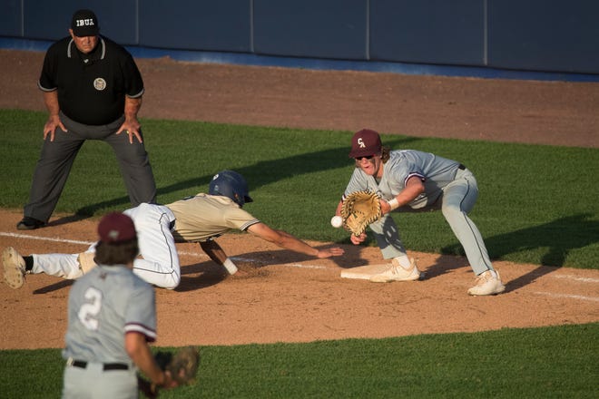 Caravel's Jared Hoffman (19) watches the ball enter his glove during a pickoff attempt at first base against DMA in the DIAA semifinals Thursday, May 27, 2021, at Frawley Stadium.
