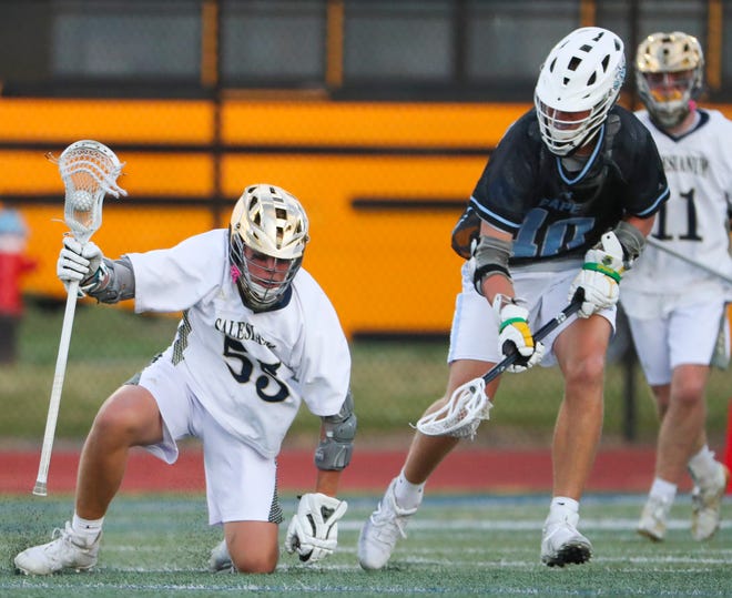 Salesianum's Ryan Metz (left) tries to regain his balance as he works again Cape Henlopen's Drew Dennis in the first half of the DIAA state tournament championship game Thursday, May 27, 2021 at Dover High School.