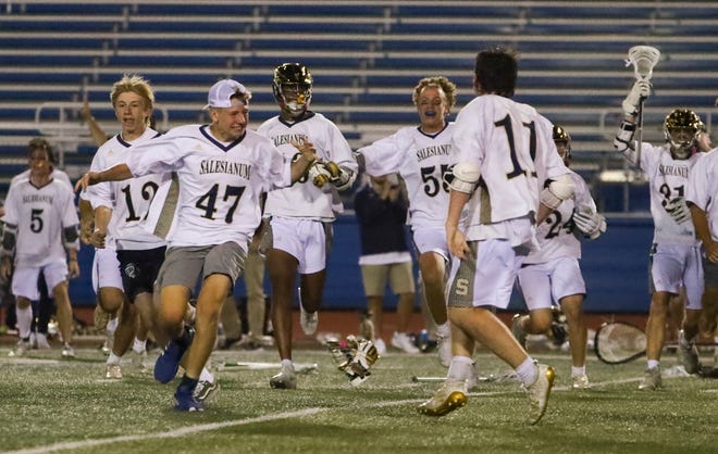 Salesianum players celebrates their 12-10 win in the DIAA state tournament championship game Thursday, May 27, 2021 at Dover High School.