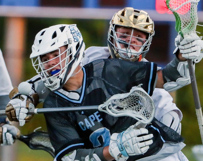 Cape Henlopen's Henry D'Ambrogi (left) loses the ball to the defense of Salesianum's Rowyn Nurry in the first half of the DIAA state tournament championship game Thursday, May 27, 2021 at Dover High School.