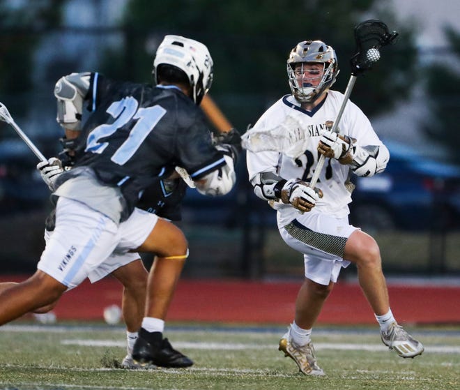 Salesianum's Griffin McGovern (right) carries out of his zone in the first half of the DIAA state tournament championship game Thursday, May 27, 2021 at Dover High School.