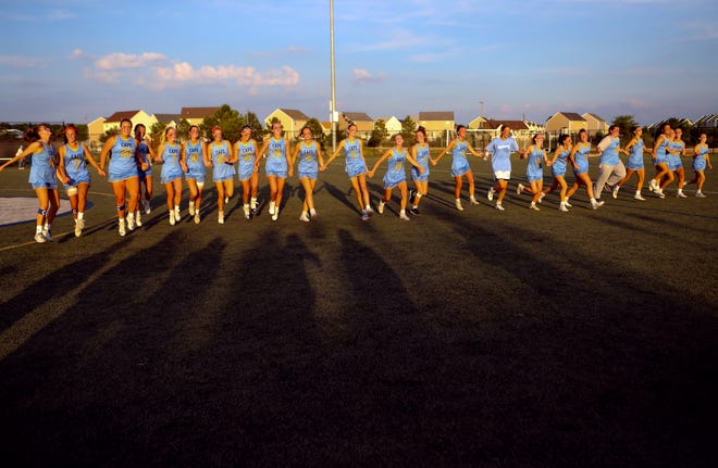 Cape Henlopen jogs across the field as a team after winning the DIAA state tournament championship game Thursday, May 27, 2021 at Dover High School.