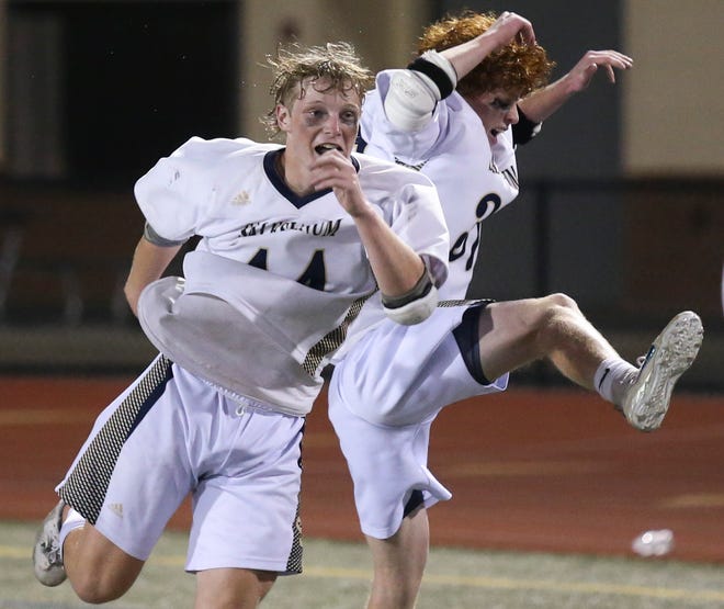 Salesianum's John Gormley (left) and Aidan Lucey come together as they celebrate Salesianum's 12-10 win in the DIAA state tournament championship game Thursday, May 27, 2021 at Dover High School.
