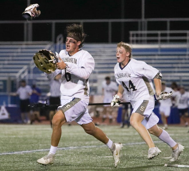 Salesianum's Jackson Skinner (left) and John Gormley run for the student section and their classmates after Salesianum's 12-10 win in the DIAA state tournament championship game Thursday, May 27, 2021 at Dover High School.