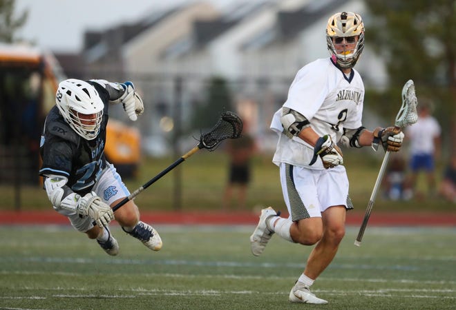 Cape Henlopen's Charles Fritchman (left) loses his footing as he purses Salesianum's Matthew Riley square off in the first half of the DIAA state tournament championship game Thursday, May 27, 2021 at Dover High School.