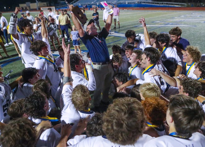 Salesianum head coach Bob Healy exults with his team after their 12-10 win in the DIAA state tournament championship game Thursday, May 27, 2021 at Dover High School.