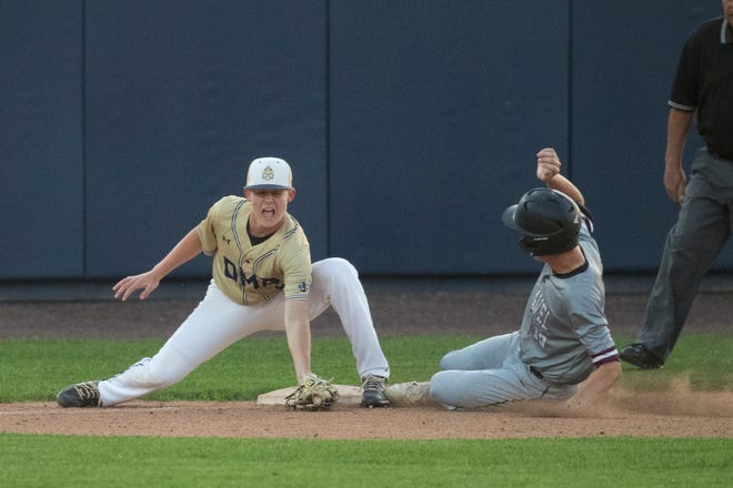 DMA's Drew Simpson (6) tags out Caravel's James Wingo (10) at third base in the DIAA semifinals Thursday, May 27, 2021, at Frawley Stadium.