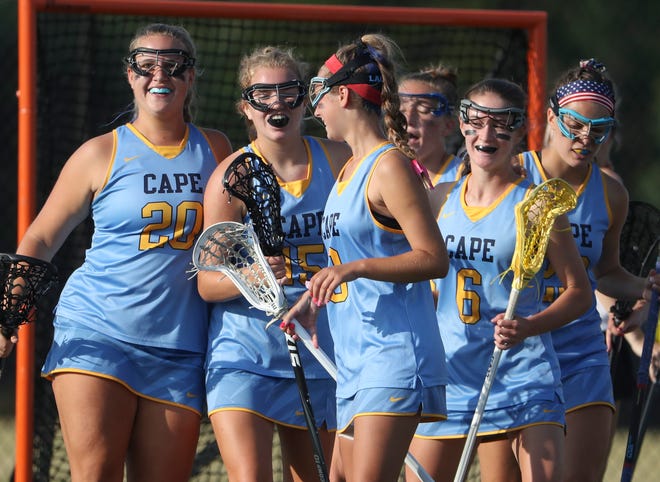 Cape Henlopen, including (from left) Riley Keen, Kelly Bragg, Haley Craig, Louise Rishko and Molly Mendes come together after a score in the first half of the DIAA state tournament title game Thursday, May 27, 2021 at Dover High School.