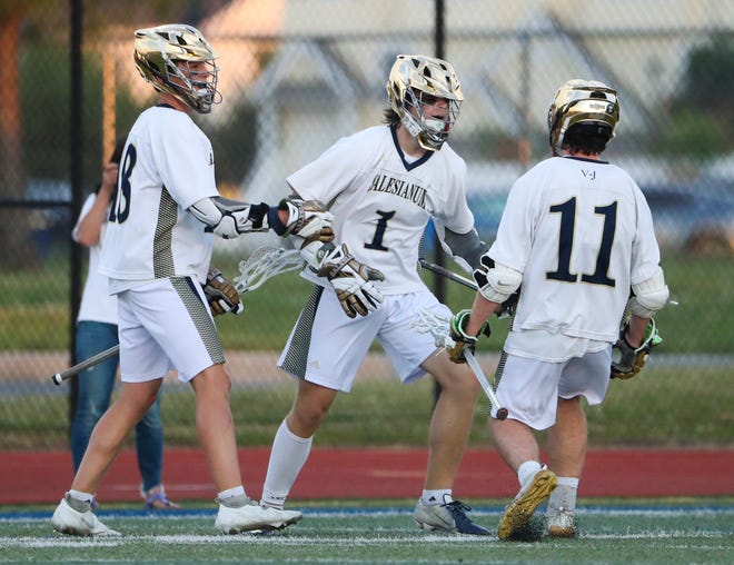 Salesianum's Caelan Driggs (1) celebrates a goal with teammates Rowyn Nurry (left) and Colby Bushweller in the first half of the DIAA state tournament championship game Thursday, May 27, 2021 at Dover High School.