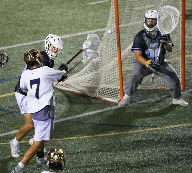 Salesianum's Dylan Mooney shoots and scores past Cape Henlopen's Nicholas Arnold and goalie Michael Sposato late in the second half of Salesianum's 12-10 win in the DIAA state tournament championship game Thursday, May 27, 2021 at Dover High School.
