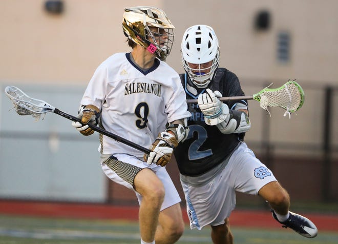 Salesianum's Charles Ruoss (left) is checked by Cape Henlopen's Henry D'Ambrogi in the first half of the DIAA state tournament championship game Thursday, May 27, 2021 at Dover High School.