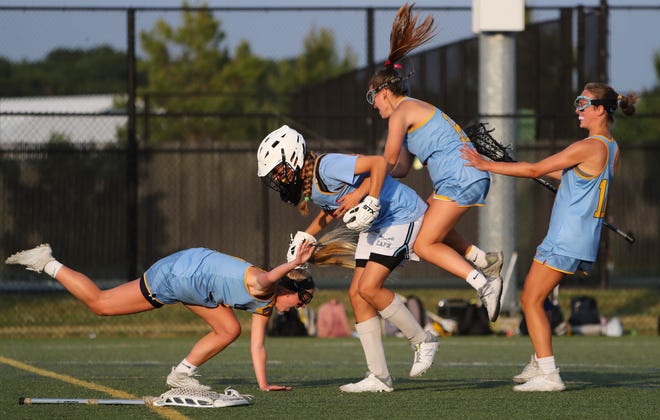 Cape Henlopen's (from left)  Alexandra Best, Destiny Kusen, Lindsay Rambo and Jocelyn Leach begin the celebration after the Vikings' 17-10 win in the DIAA state tournament championship game Thursday, May 27, 2021 at Dover High School.