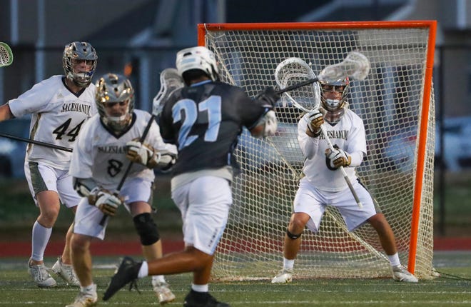 Salesianum goalie Jackson Skinner challenges a shot by Cape Henlopen's Jaden Davis in the first half of the DIAA state tournament championship game Thursday, May 27, 2021 at Dover High School.