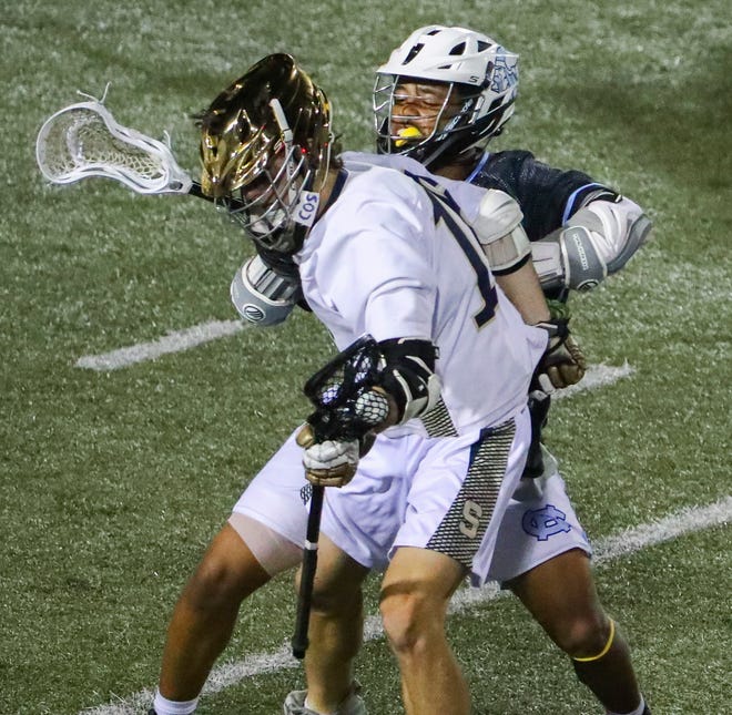 Cape Henlopen's Jaden Davis checks Salesianum's Kaleb Russell in the second half of Salesianum's 12-10 win in the DIAA state tournament championship game Thursday, May 27, 2021 at Dover High School.