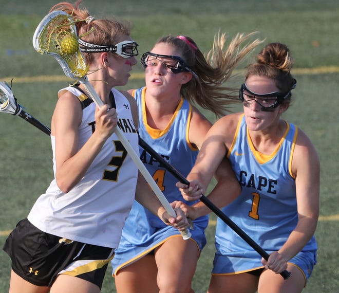 Tatnall's Kali Clayton (left) carries against Cape Henlopen's Alexi Nowakowski (center) and Montana Jones in the second half the Vikings' 17-10 win in the  DIAA state tournament championship game Thursday, May 27, 2021 at Dover High School.