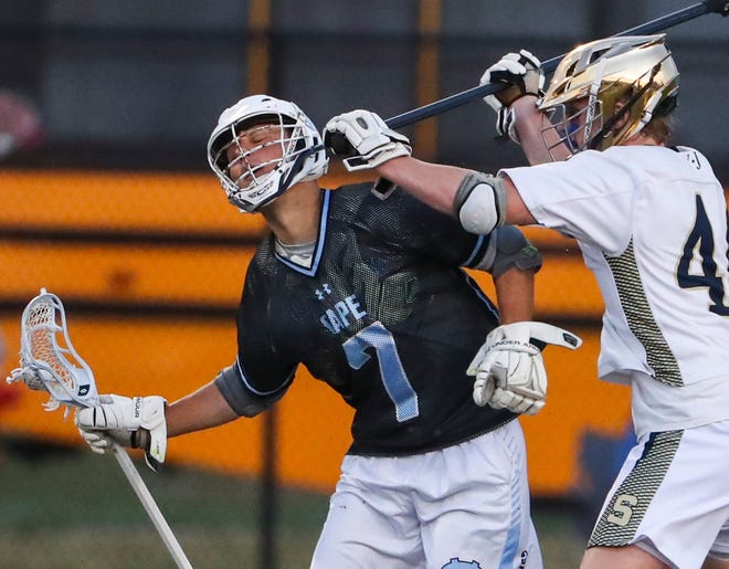 Cape Henlopen's Gabriel Best absorbs a high blow from Salesianum's John Gormley in the first half of the DIAA state tournament championship game Thursday, May 27, 2021 at Dover High School.