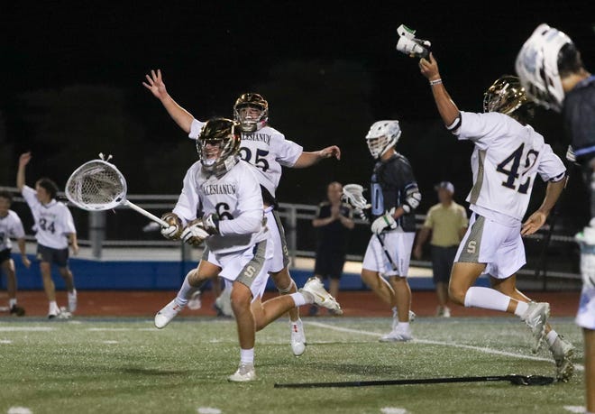 Salesianum goalie Jackson Skinner heads for the student section with teammates Dominic Rottura (rear) and Chase Cellucci after Salesianum's 12-10 win in the DIAA state tournament championship game Thursday, May 27, 2021 at Dover High School.