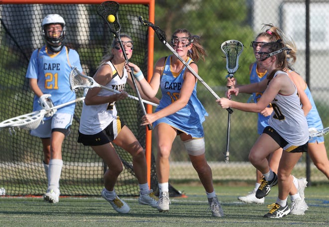 Cape Henlopen's Emily Monigle moves the ball away from the Cape net in the first half of the DIAA state tournament title game Thursday, May 27, 2021 at Dover High School.