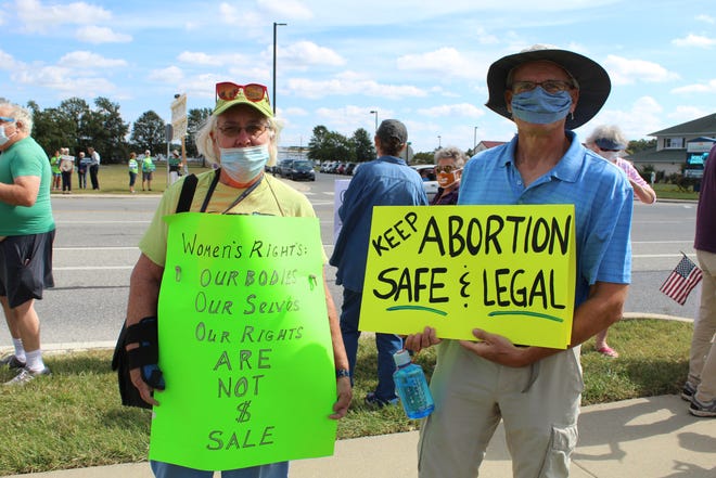 Activists supporting reproduction rights joined the Women's March in Seaford on Saturday, Oct. 2, 2021, outside the site of a new Planned Parenthood clinic. Here, Cherie Clark of Laurel and David Fees of Seaford hold signs.