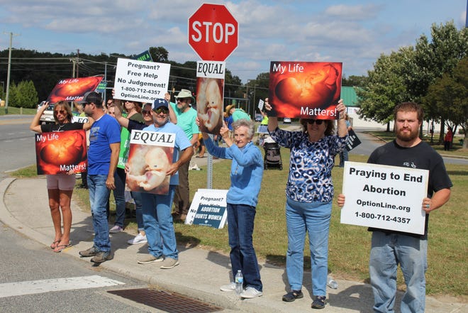 Counter protesters held signs in opposition to abortions and Planned Parenthood in Seaford on Saturday, Oct. 2, 2021.