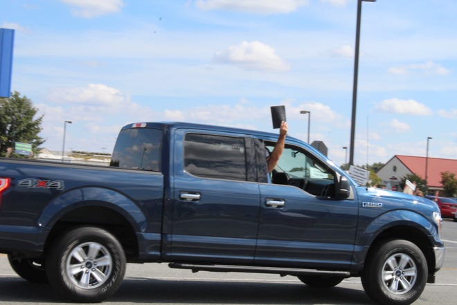 While activists spoke about supporting reproduction rights at the Women's March in Seaford on Saturday, Oct. 2, 2021, counter protesters drove up and down the highway honking and holding Bibles out the window.