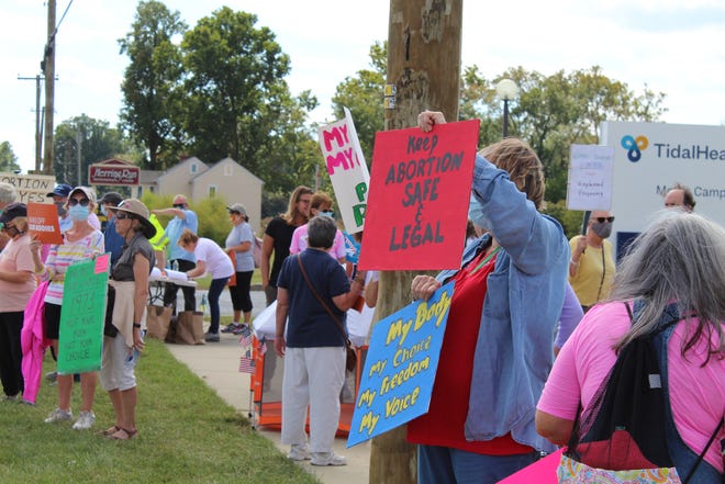 Activists supporting reproduction rights joined the Women's March in Seaford on Saturday, Oct. 2, 2021, outside the site of a new Planned Parenthood clinic. On the other side of the highway were many counter protesters in opposition to abortions and Planned Parenthood.
